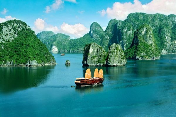 Limestone karst islands rising from calm water in Ha Long Bay
