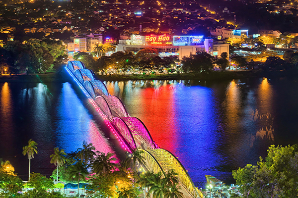 Trang Tien Bridge lit up at night over the Perfume River in Hue